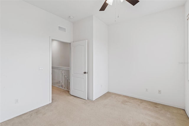 carpeted spare room with ceiling fan