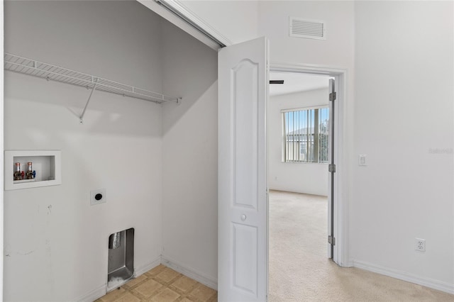 clothes washing area featuring hookup for an electric dryer, washer hookup, and light carpet