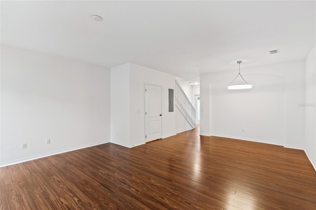 unfurnished room with dark hardwood / wood-style flooring and electric panel