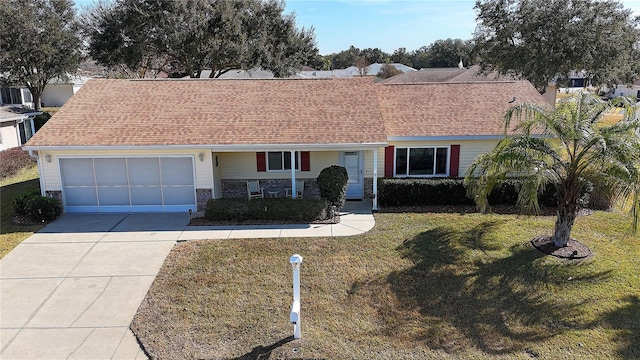 ranch-style home featuring a garage and a front lawn