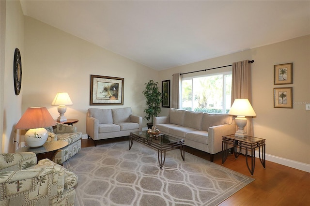 living room featuring hardwood / wood-style flooring and vaulted ceiling