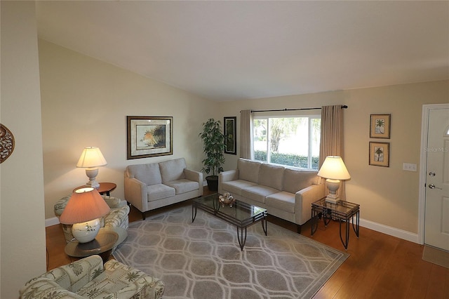 living room with lofted ceiling and hardwood / wood-style floors