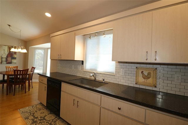 kitchen with decorative light fixtures, lofted ceiling, black dishwasher, sink, and light brown cabinets