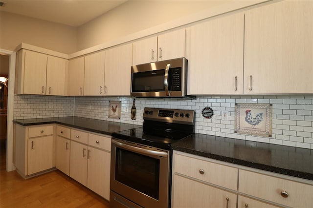 kitchen featuring light hardwood / wood-style flooring, appliances with stainless steel finishes, dark stone countertops, backsplash, and light brown cabinetry