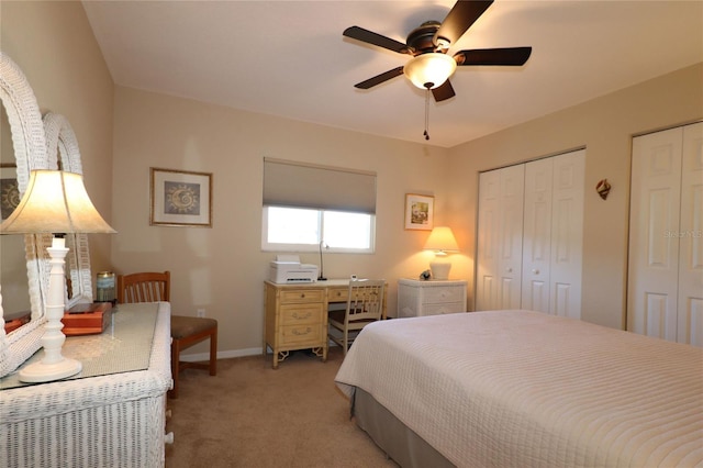 carpeted bedroom featuring two closets and ceiling fan