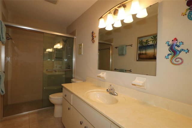 bathroom with tile patterned floors, toilet, an enclosed shower, and vanity