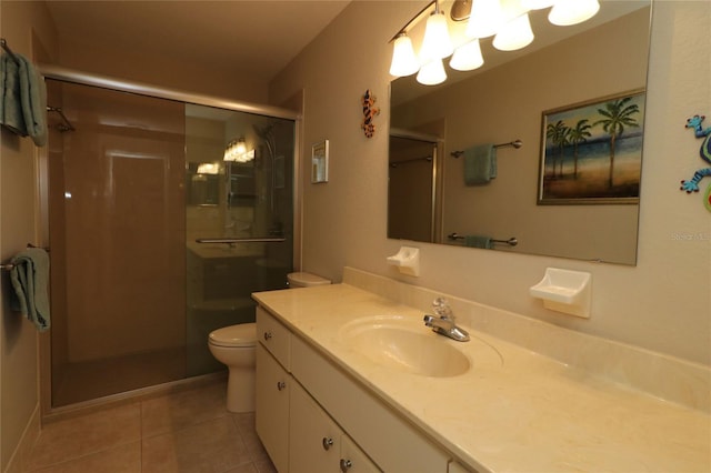 bathroom featuring vanity, toilet, a shower with shower door, and tile patterned flooring