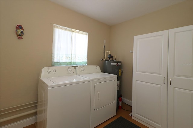 laundry room with washing machine and dryer and water heater