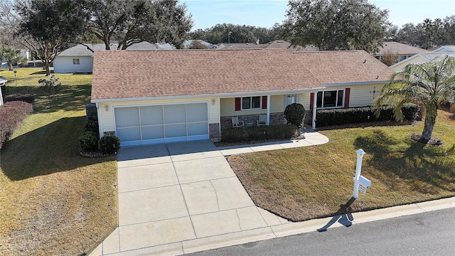 ranch-style house featuring a garage and a front lawn