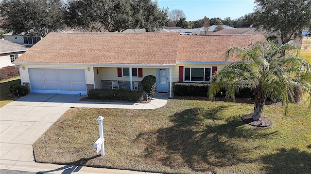 single story home with a garage and a front lawn