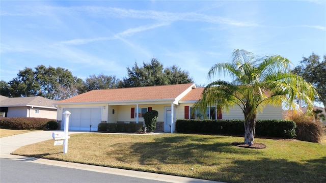 single story home featuring a garage and a front lawn