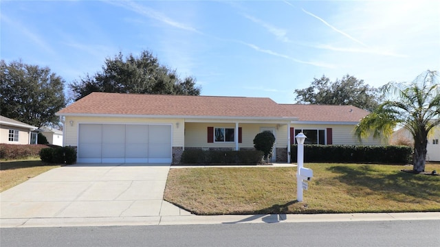 ranch-style house featuring a garage and a front lawn