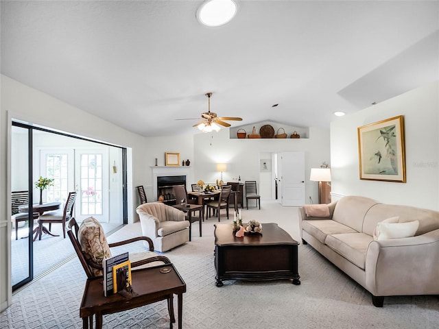 living room with lofted ceiling, light colored carpet, and ceiling fan