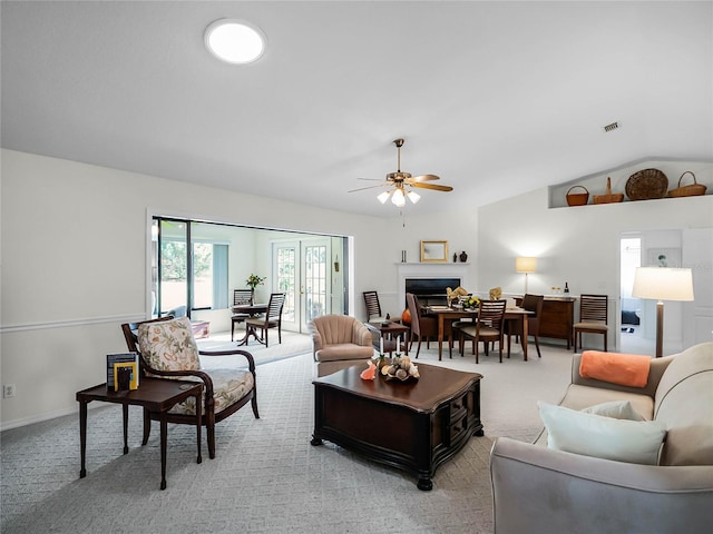 living room with lofted ceiling, light carpet, and ceiling fan