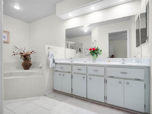 bathroom featuring vanity and separate shower and tub