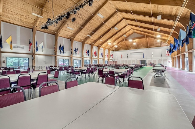 dining space featuring track lighting, wooden ceiling, and high vaulted ceiling