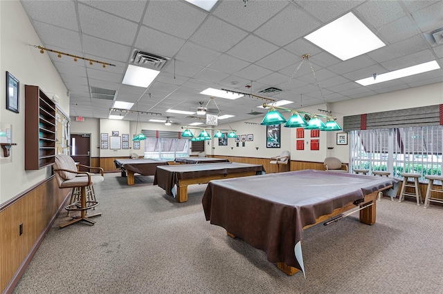 rec room featuring a drop ceiling, pool table, wooden walls, and carpet