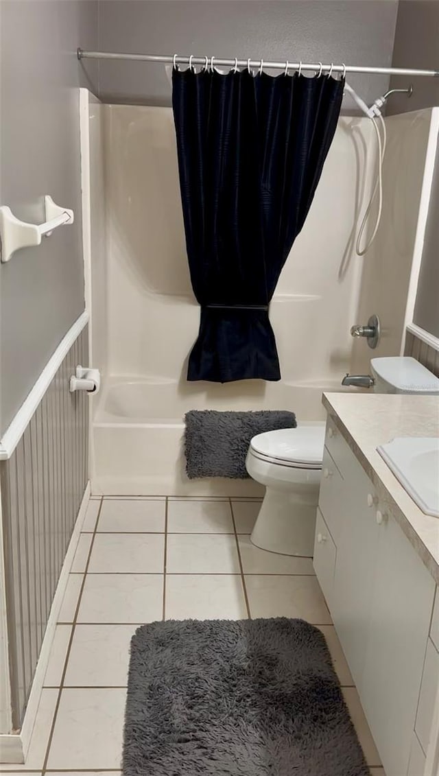 full bathroom with toilet, tile patterned floors, vanity, and shower / bathtub combination with curtain