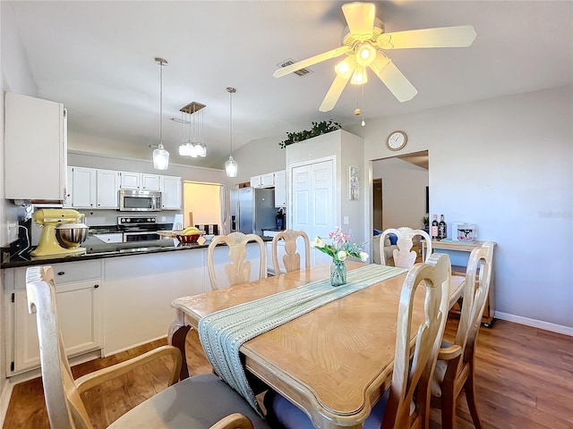 dining space with dark hardwood / wood-style floors and ceiling fan