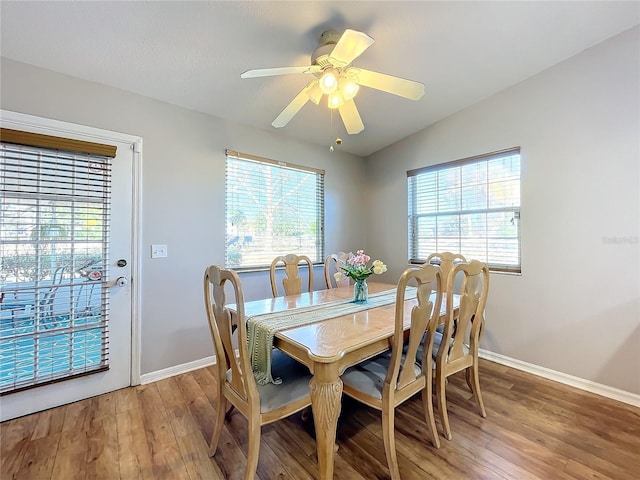 dining space with hardwood / wood-style flooring, a wealth of natural light, and ceiling fan