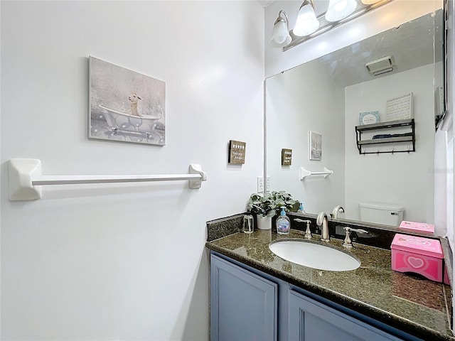 bathroom with vanity and toilet