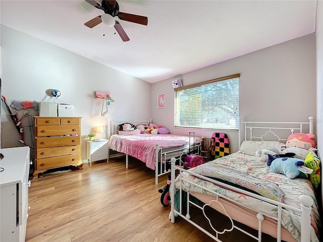 bedroom with light hardwood / wood-style flooring and ceiling fan