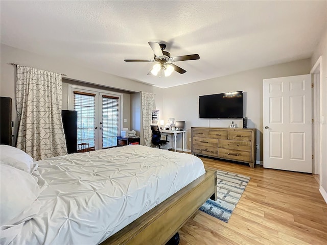 bedroom with french doors, a textured ceiling, ceiling fan, access to exterior, and hardwood / wood-style floors