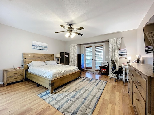 bedroom featuring ceiling fan, a textured ceiling, access to outside, french doors, and light wood-type flooring