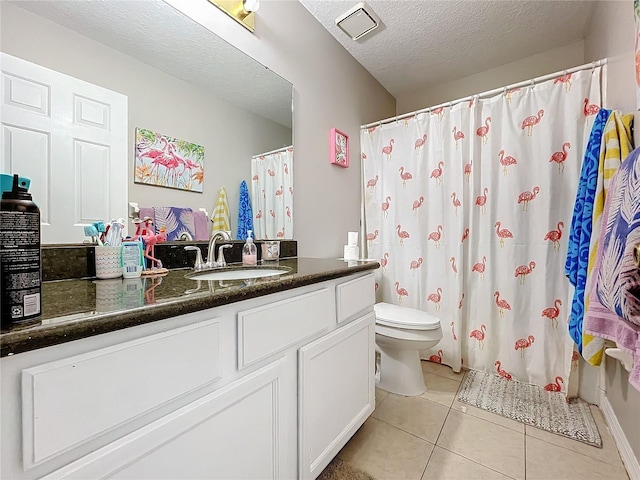 bathroom featuring a shower with shower curtain, vanity, a textured ceiling, tile patterned floors, and toilet