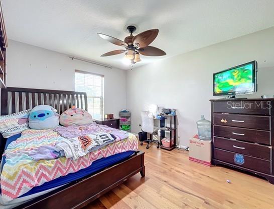 bedroom featuring ceiling fan and light hardwood / wood-style floors