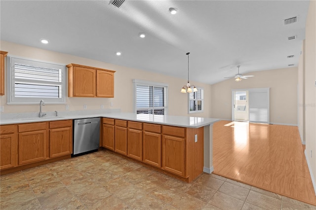 kitchen featuring lofted ceiling, sink, dishwasher, hanging light fixtures, and kitchen peninsula