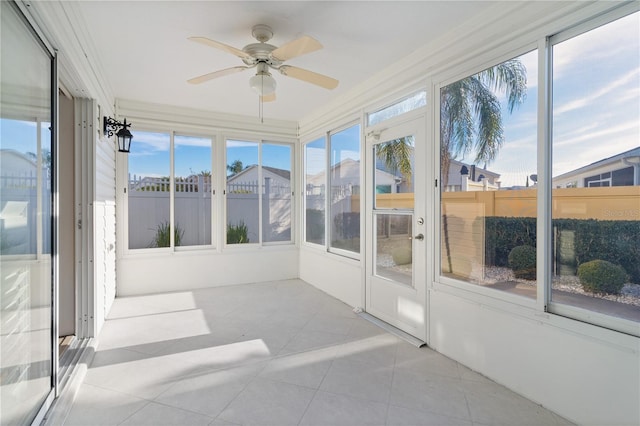 sunroom with plenty of natural light and ceiling fan