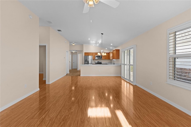 unfurnished living room with ceiling fan, sink, and light wood-type flooring