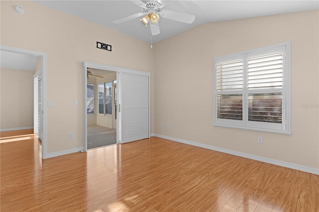 empty room with vaulted ceiling, light hardwood / wood-style floors, and ceiling fan