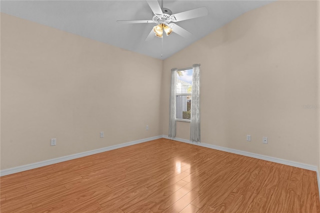 empty room featuring light hardwood / wood-style flooring, vaulted ceiling, and ceiling fan