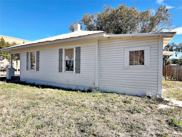 view of side of home featuring a yard