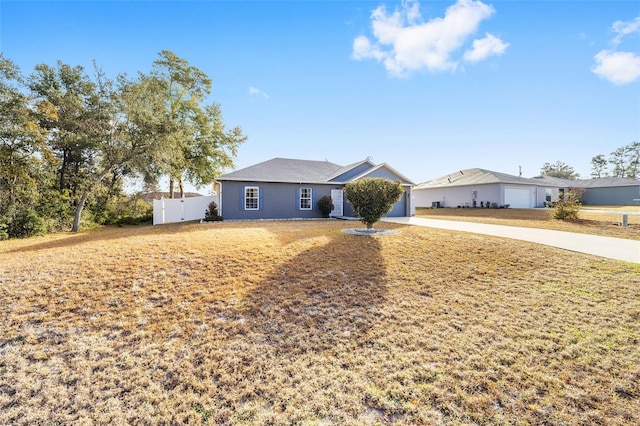 ranch-style home with a garage and a front yard