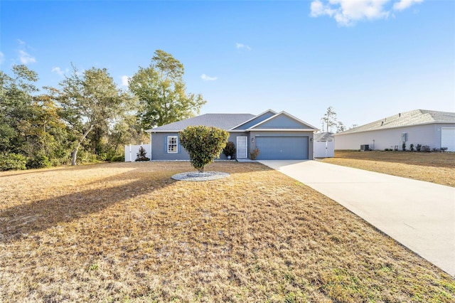 ranch-style home with a garage and a front lawn