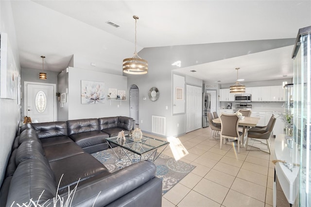 living room featuring lofted ceiling and light tile patterned flooring