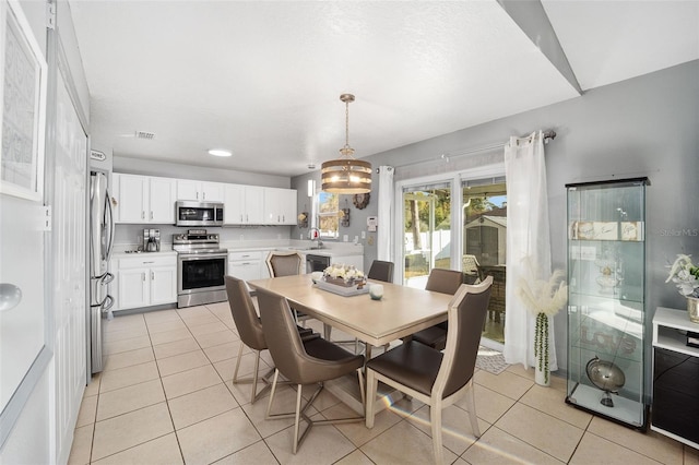 dining room with light tile patterned floors and sink