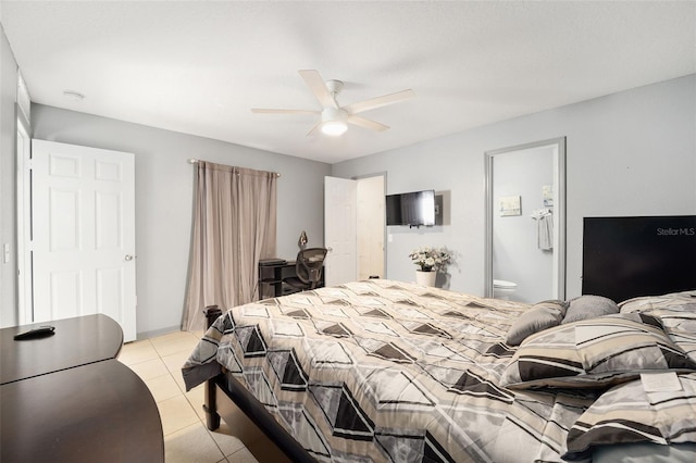 bedroom featuring light tile patterned flooring, ceiling fan, and ensuite bath