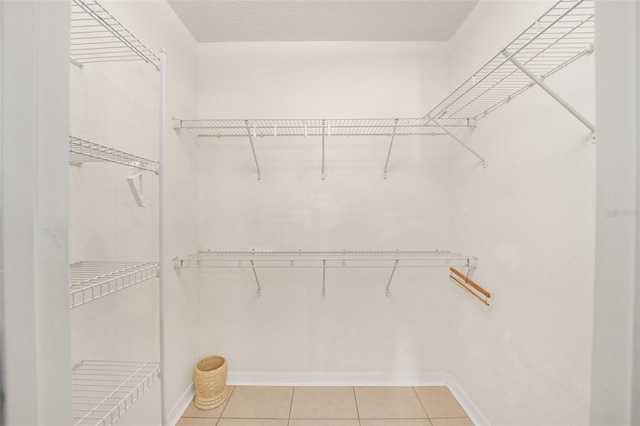 walk in closet featuring light tile patterned flooring