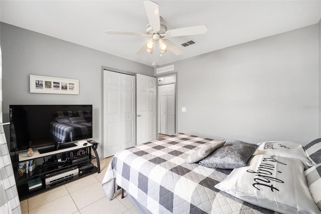 bedroom with ceiling fan, a closet, and light tile patterned floors