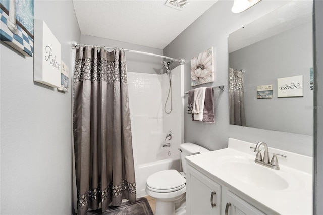 full bathroom featuring vanity, toilet, a textured ceiling, and shower / bath combo