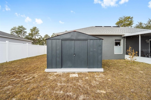 view of outbuilding with a lawn