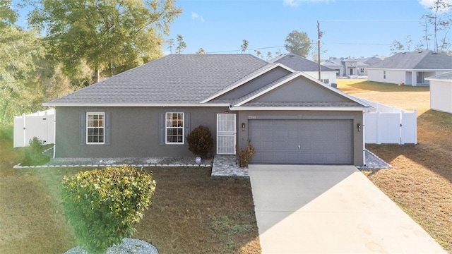 single story home featuring a garage and a front lawn