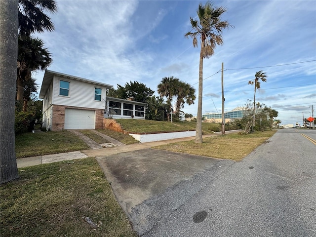 split level home with a garage and a front yard