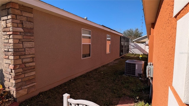 view of side of property with central AC