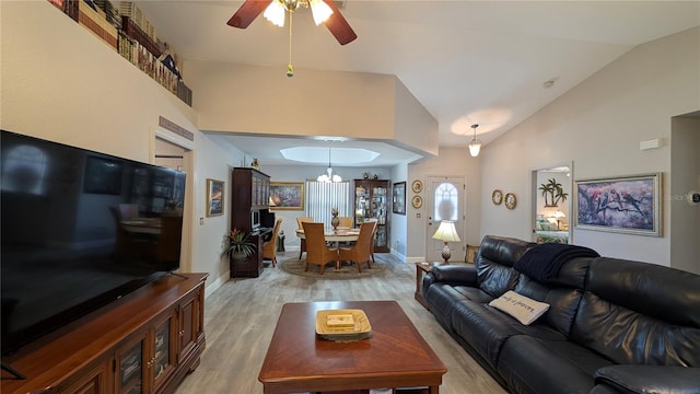 living room with ceiling fan, lofted ceiling, and light wood-type flooring