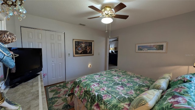 bedroom featuring ceiling fan and a closet